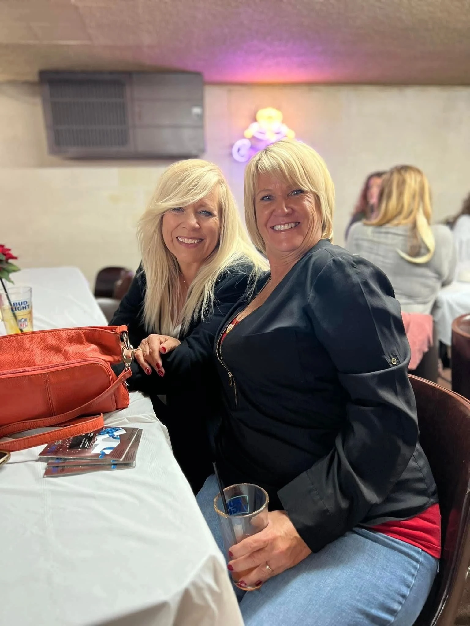 Two friends smiling at a holiday brunch table