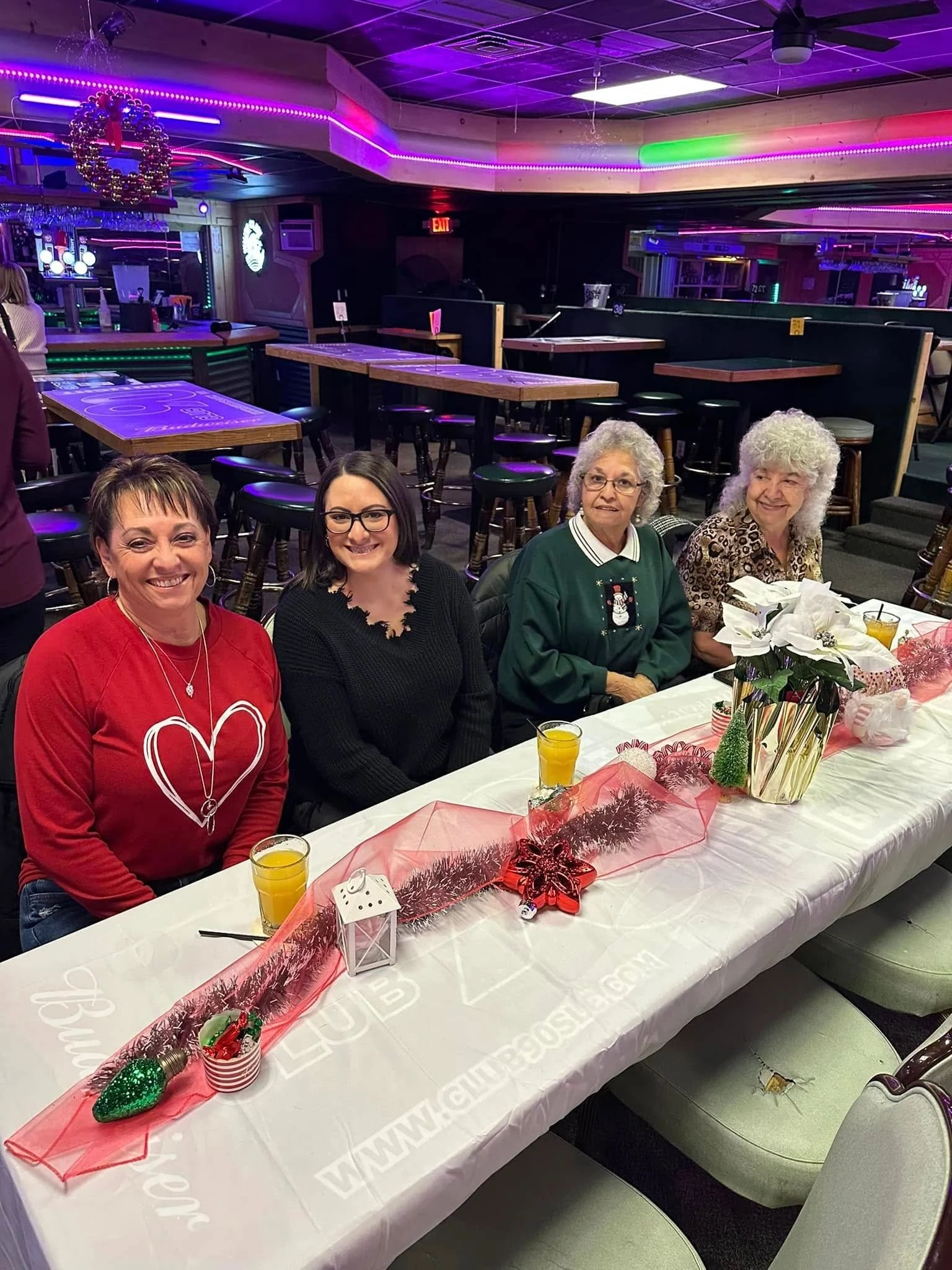 Four guests gathered at a decorated table during an Ornament Exchange